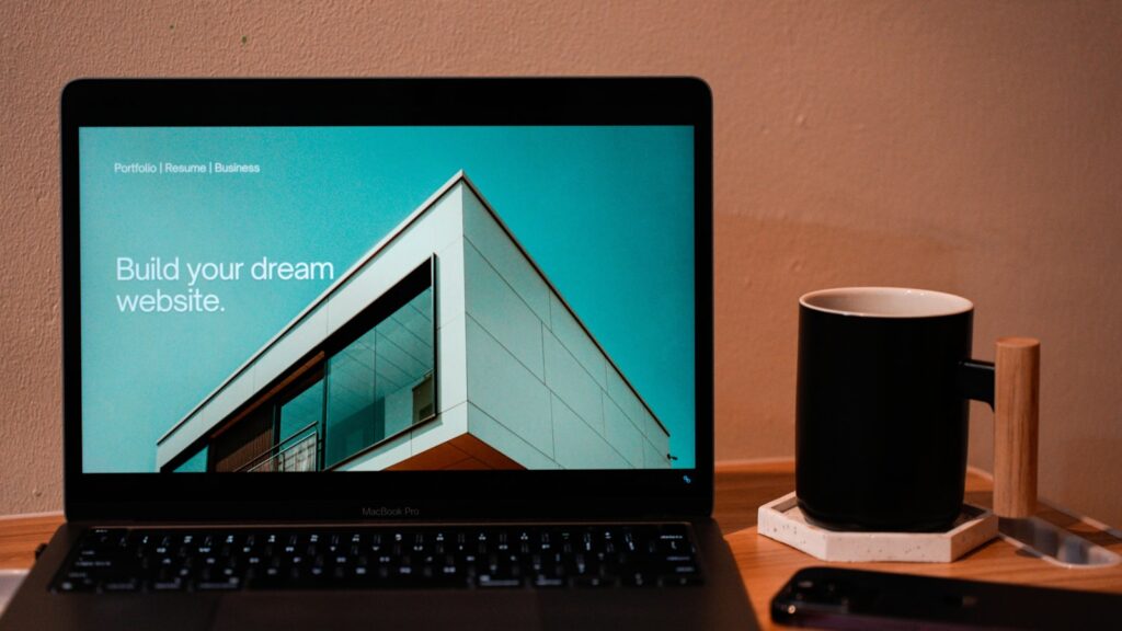 A laptop computer sitting on top of a wooden desk – How Long Does It Really Take to Build a Website with AI?
