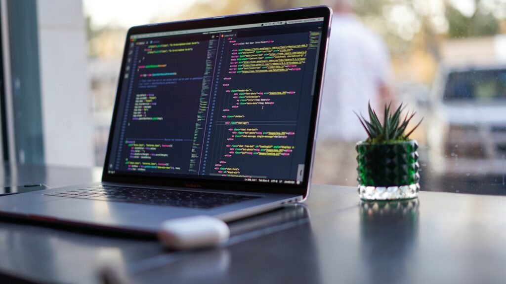 Black laptop computer turned on on table – Architecting Radar Researcher: Cloudflare’s Code Mode AI Agent and WebMCP Integration