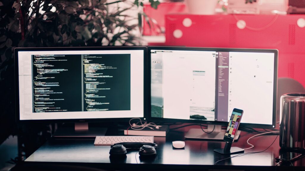Two black computer monitors on black table – Styling Grid and Flexbox Spacing: The Complete Guide to CSS Gap Decorations